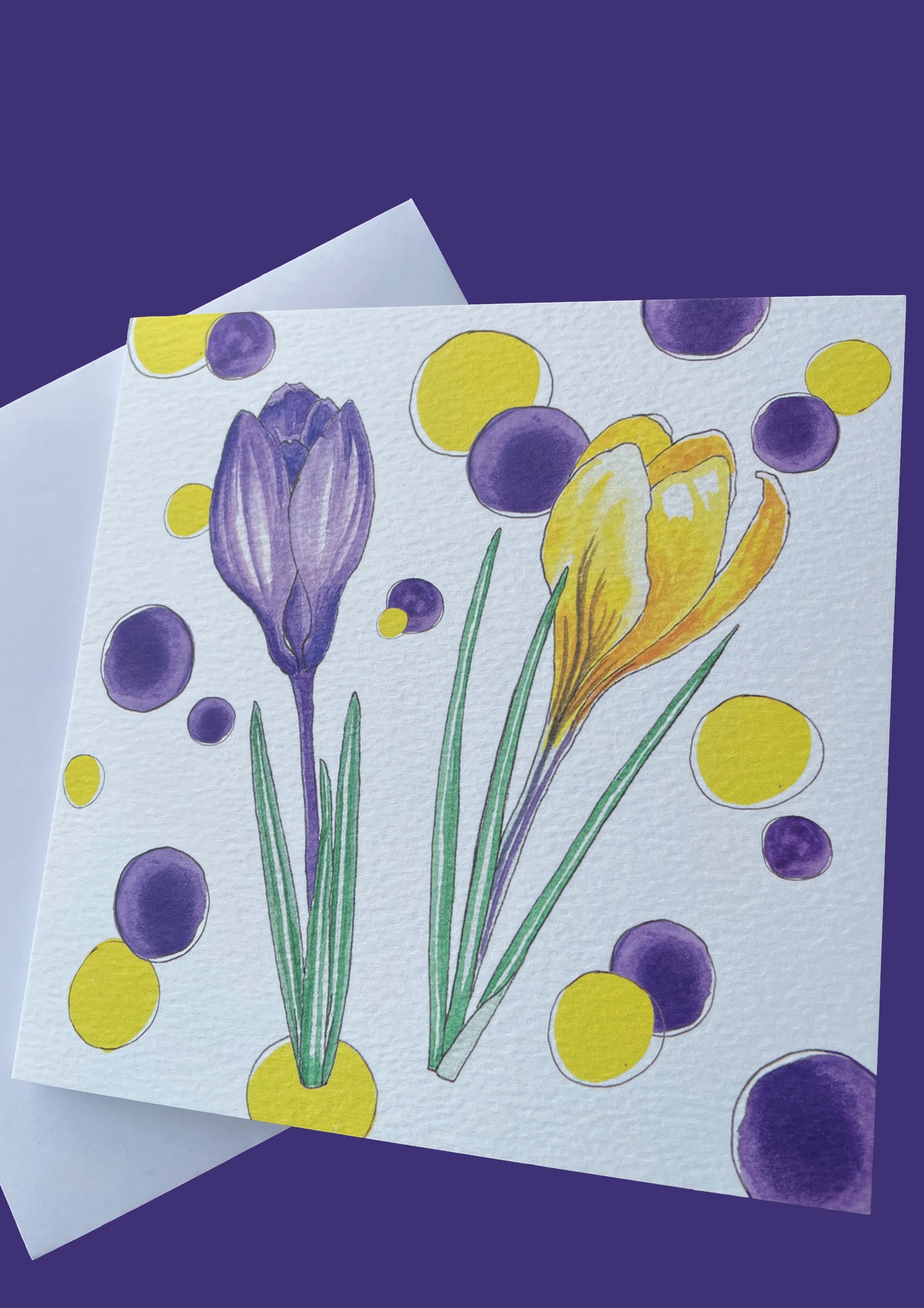 Water colour crocuses and spot design in yellow and purple on art paper card