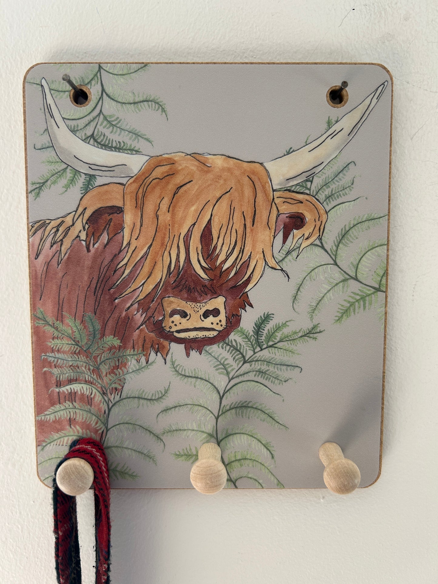 Highland cow design on an old fashioned peg hook