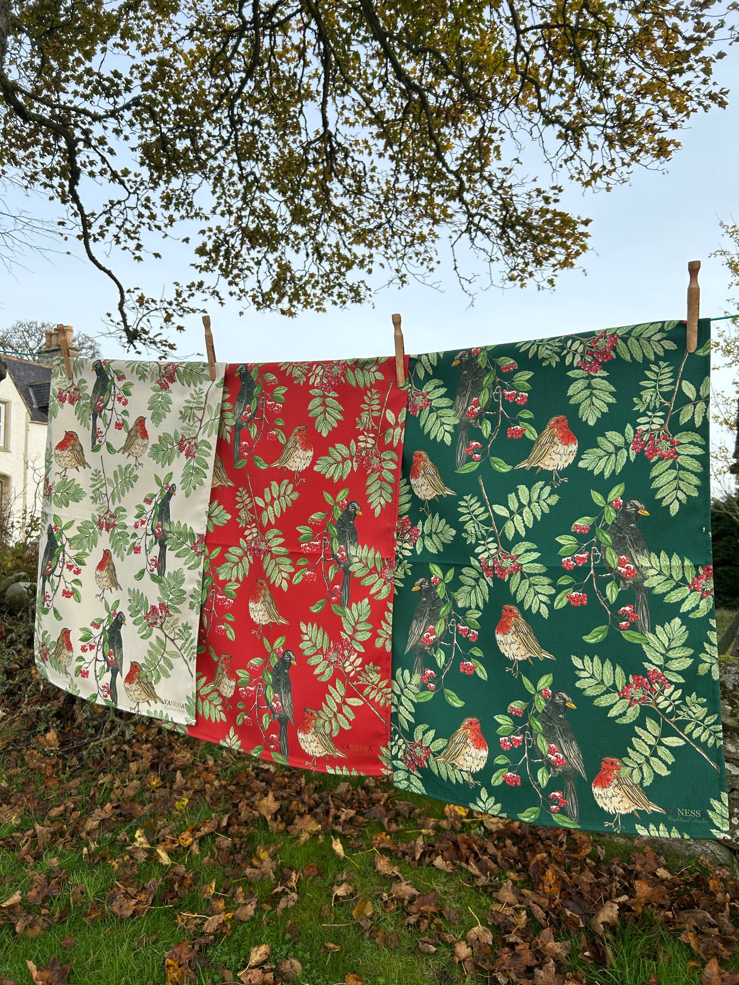 Decorative fabric with nature-themed pattern hanging outdoors.