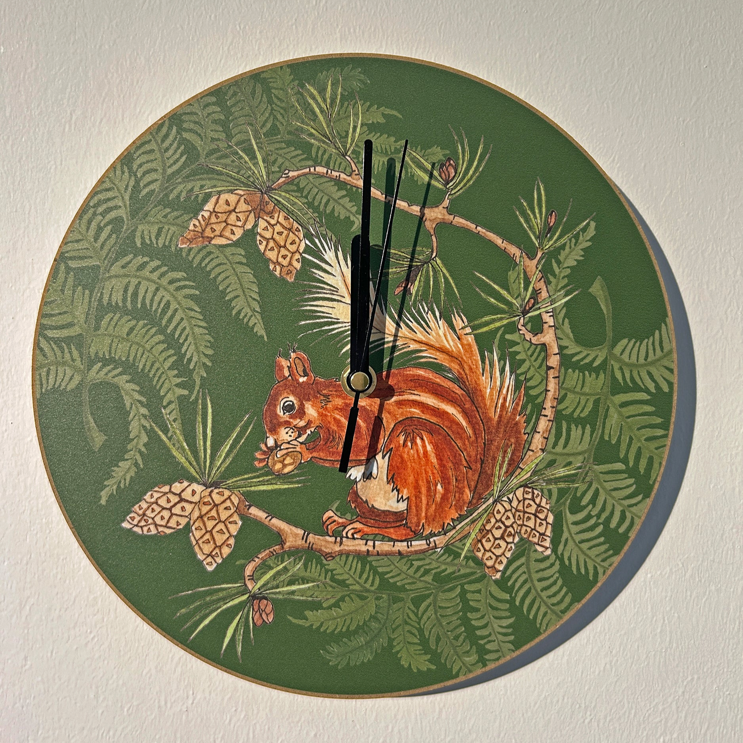 Red squirrel and fern illustrated clock with green background