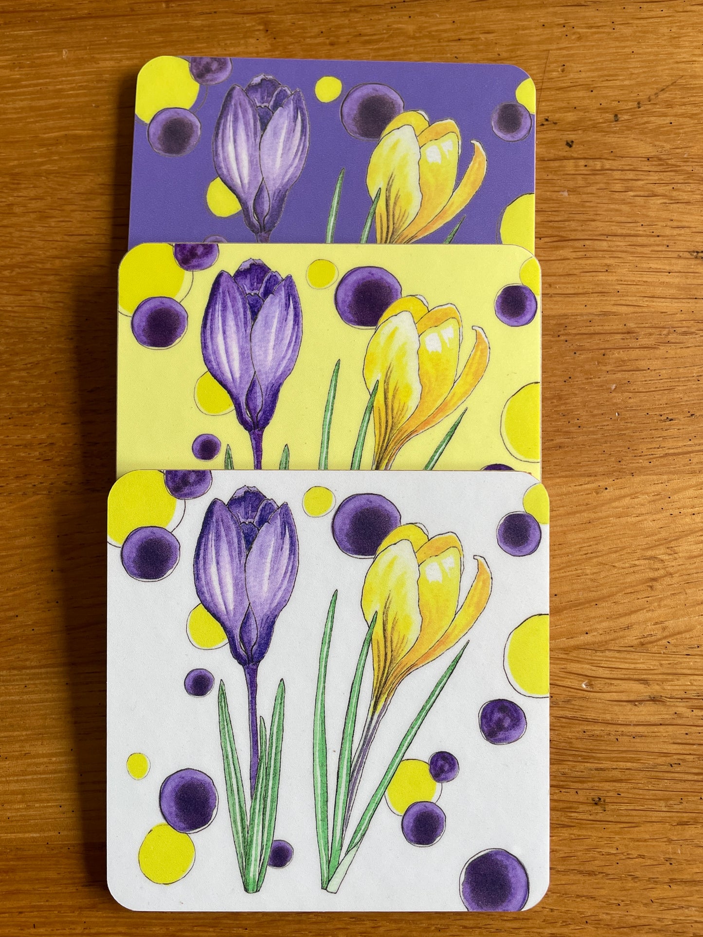 Three colours of cork coaster with Crocus Design illustration Purple, Yellow and White