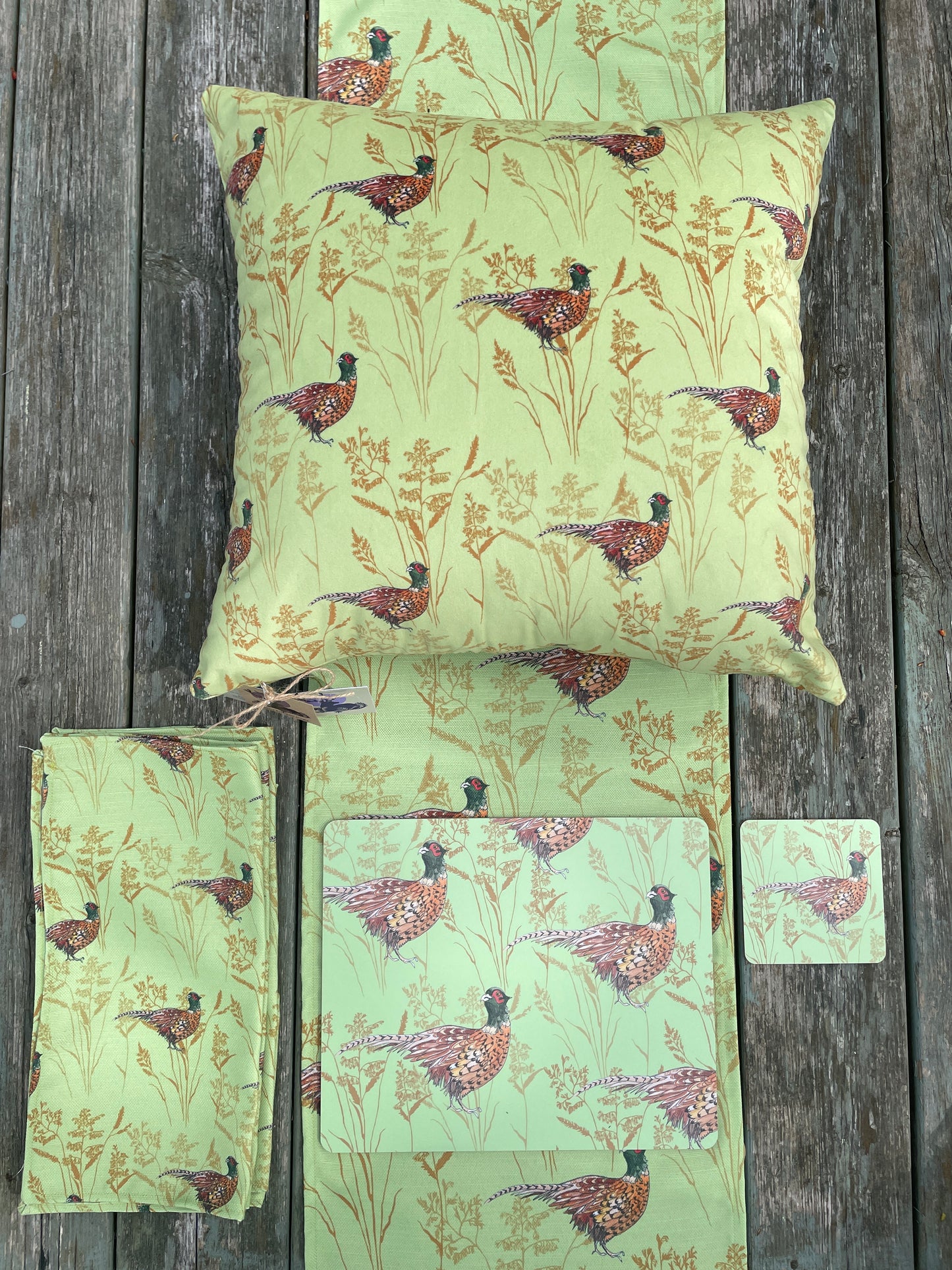 Collection of lime green pheasant and grass design products. Scottish design. Velvet cushion, napkins and placemats