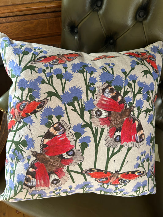Large Scottish Peacock butterfly illustrations on a background of purplw and green thistles. 43cm cushion cover design