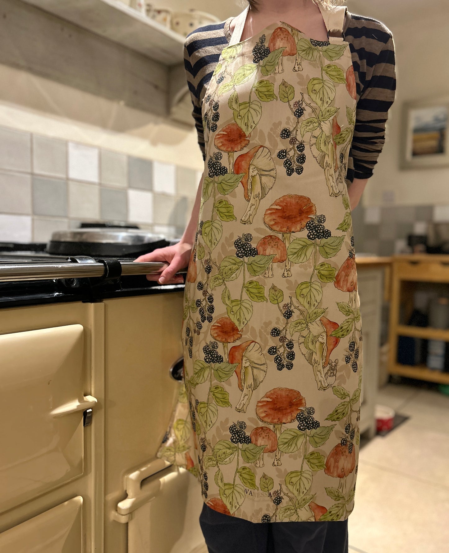 Orange toadstools and bramble illustrated design on a cream background. Country Kitchen Apron