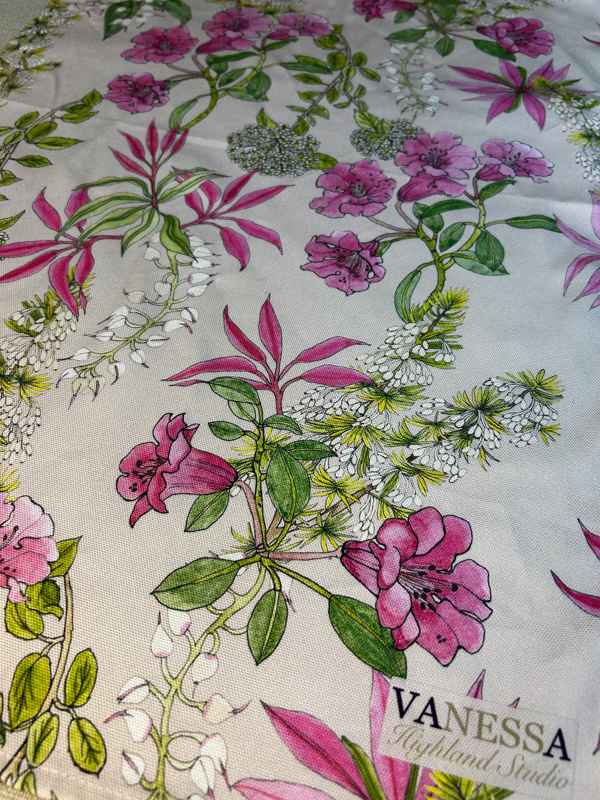 Floral patterned fabric with pink and green flowers on a neutral background, featuring the brand 'Vanessa'.