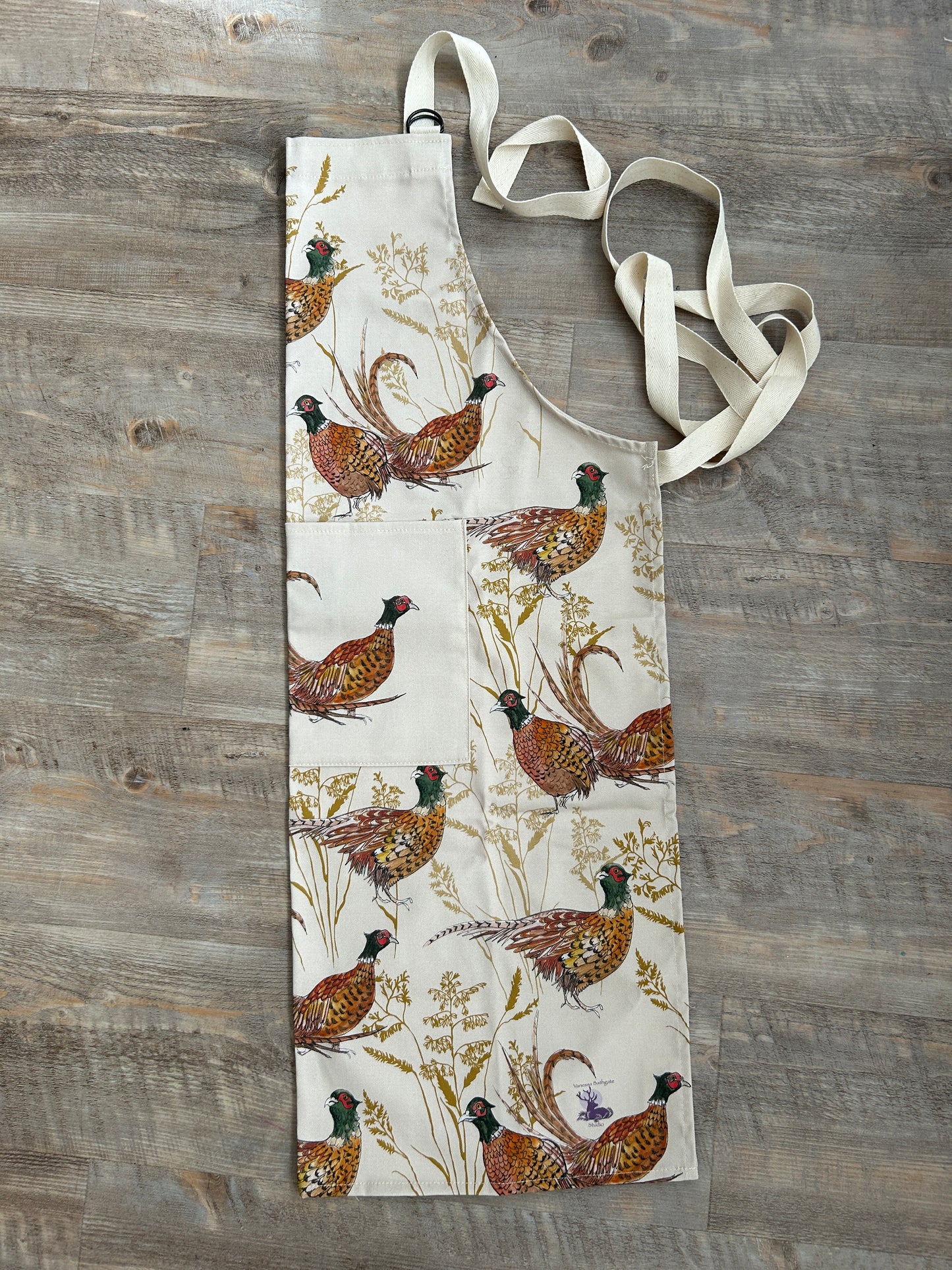 Pheasant design apron on beige background