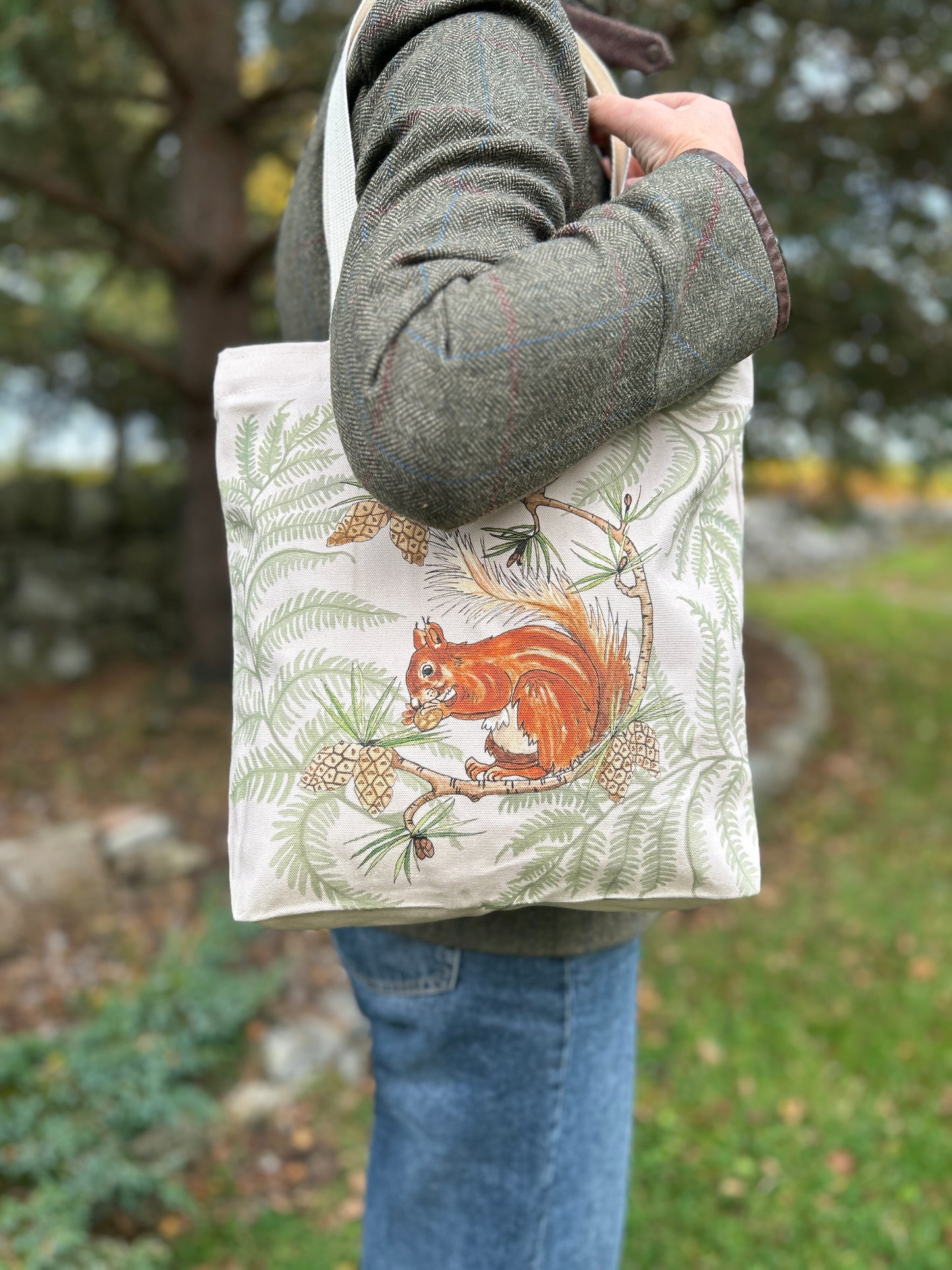 Red squirrel and fern design on a cream tote bag