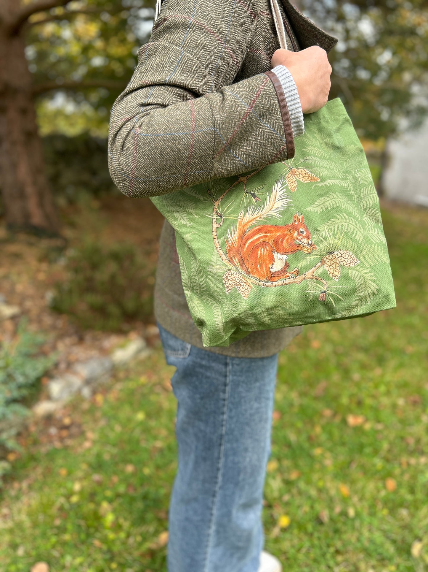 Red squirrel and fern design with green background on a cotton one bag