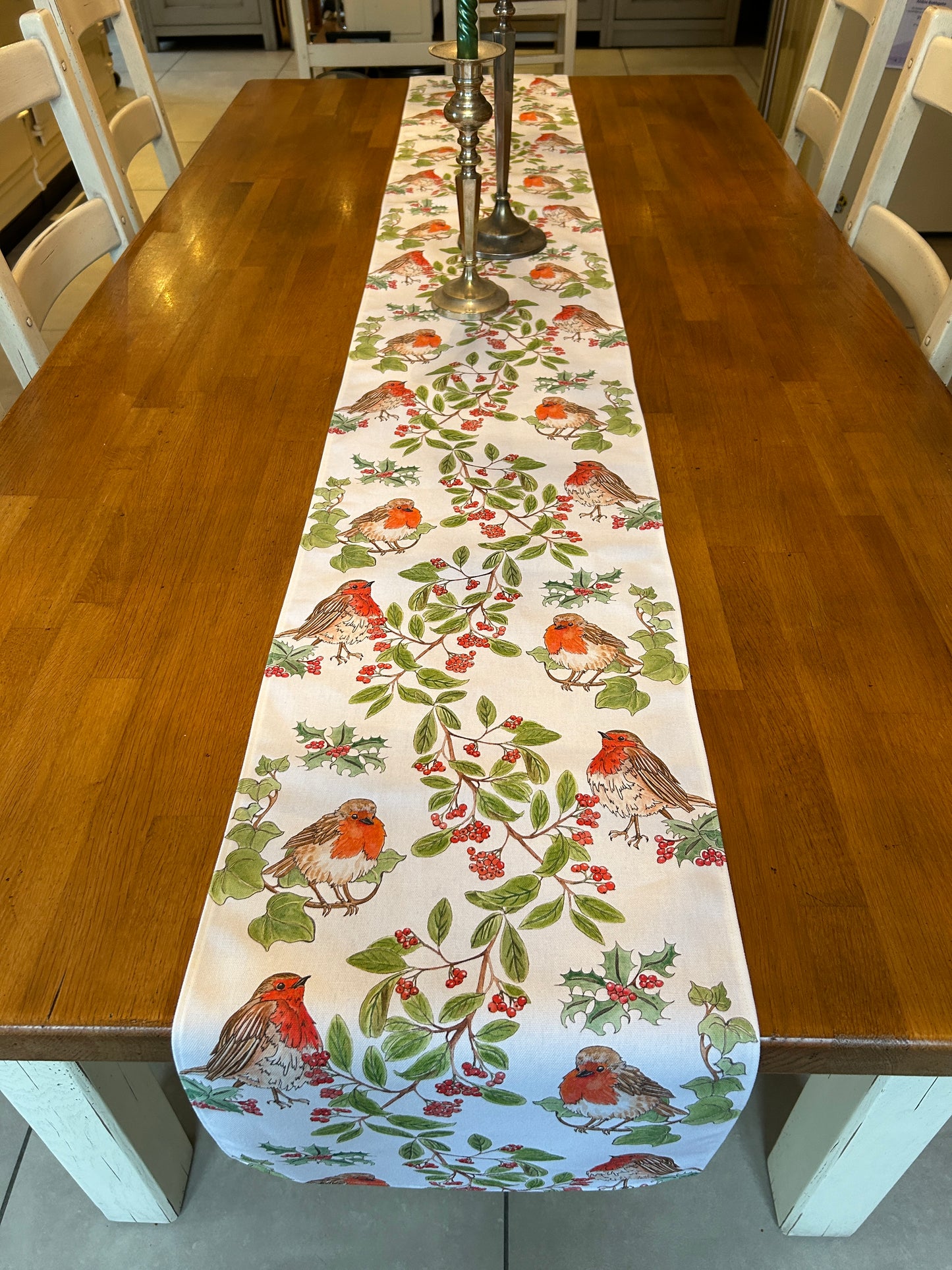 White cotton table runner with red robins and garland design