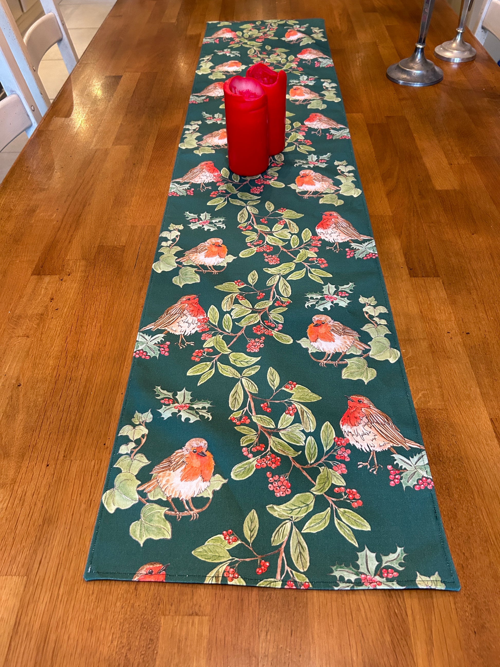 Garland and robin table runner in dark green on oak table