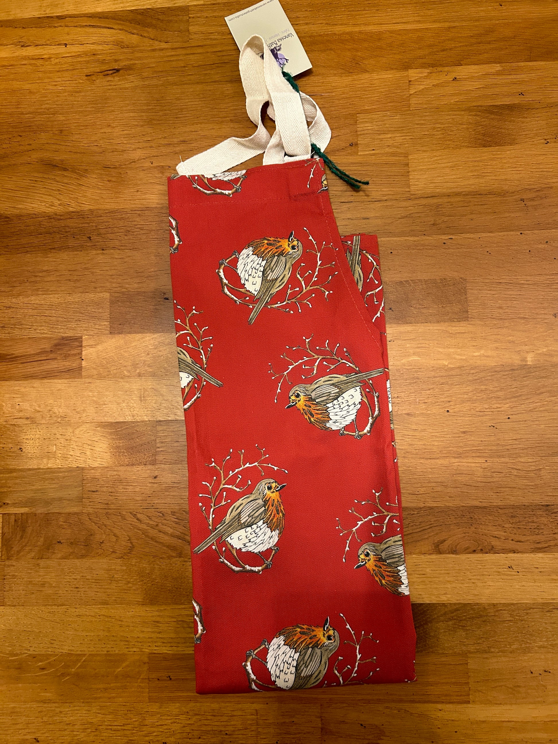 Red Robin design on a deep red background, apron with straps