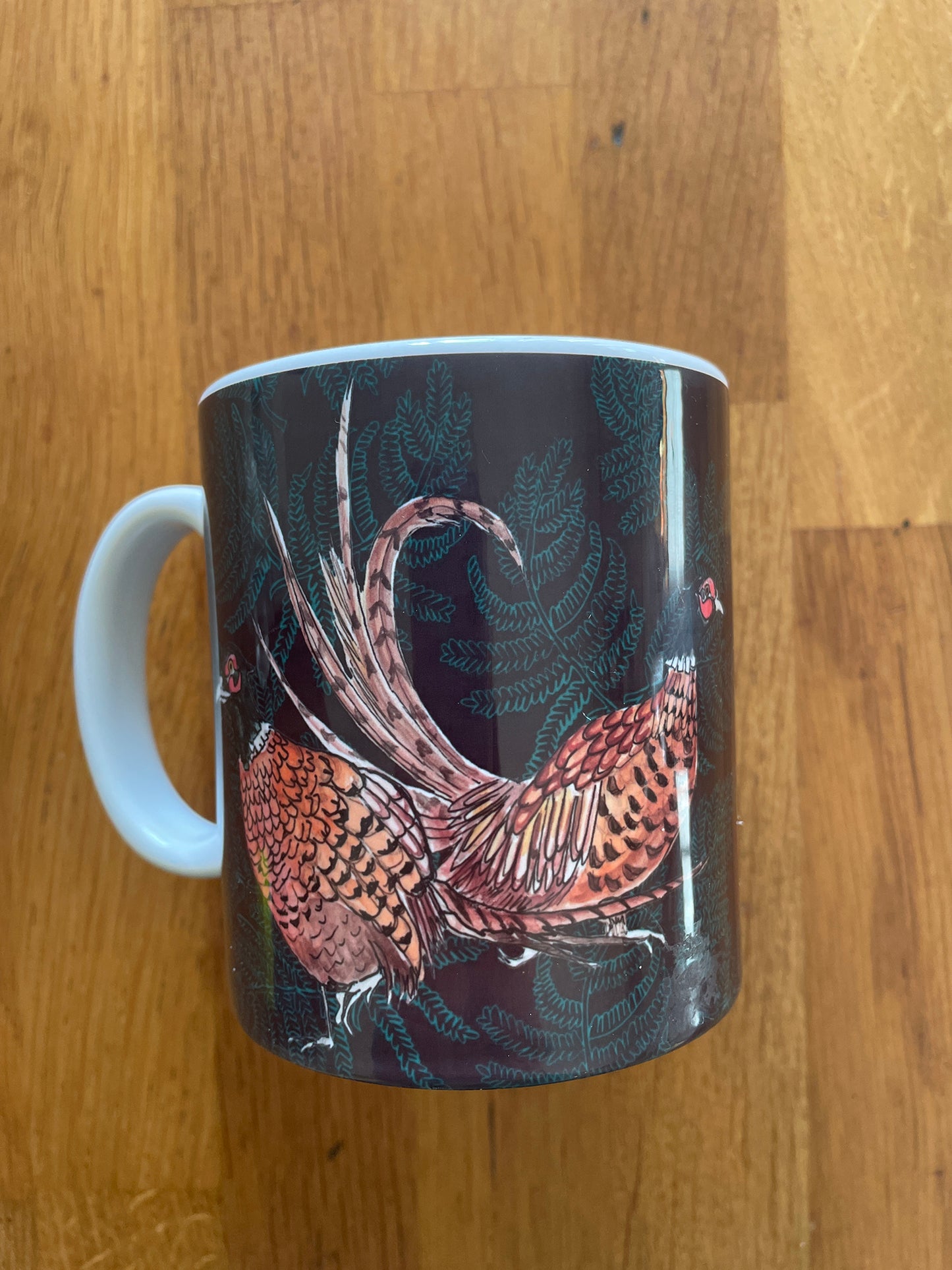 Ceramic mug with brown pheasant fern illustration 