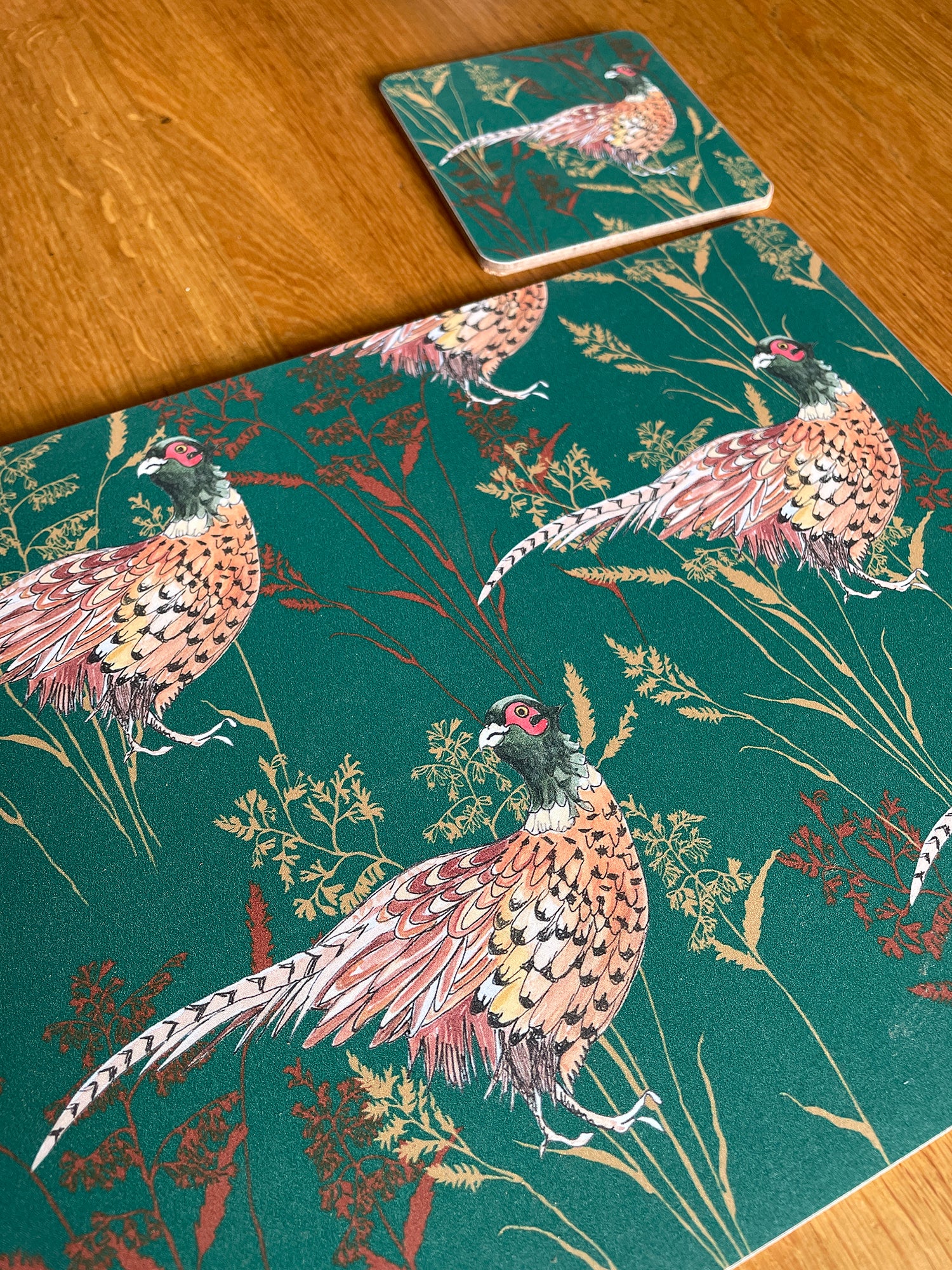 Pheasant placemat with matching coaster in bottle green