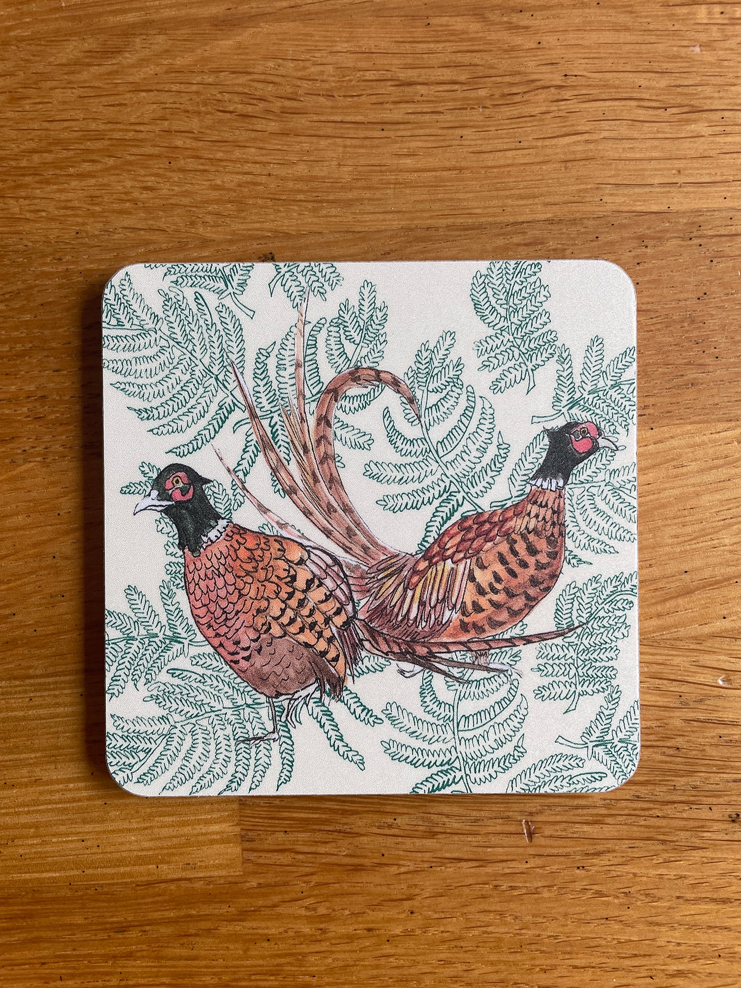 Coaster with pheasant and fern design in beige