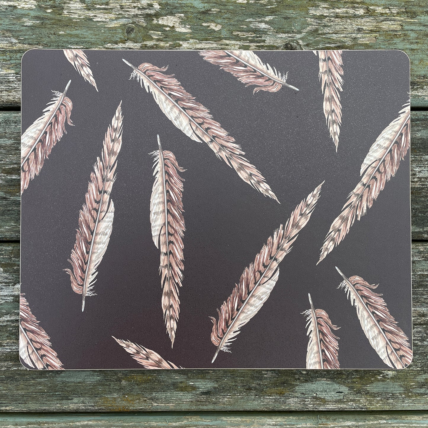 Brown placemat with pheasant feather illustration