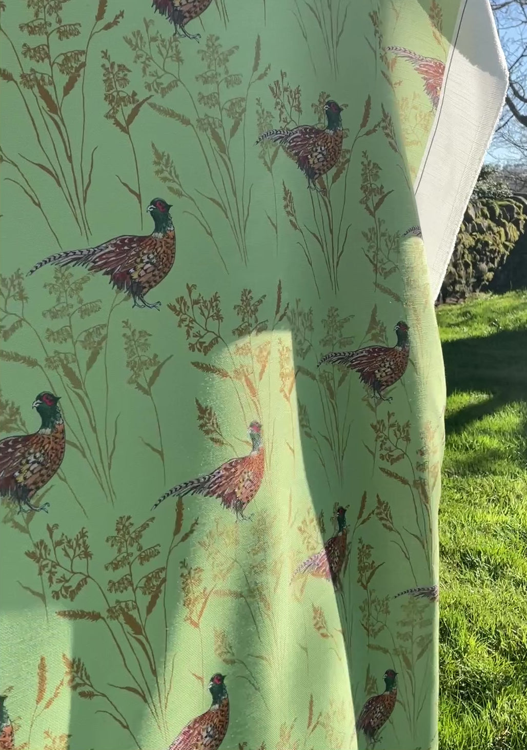 Summer Pheasant design. Green light weight table cloth  flapping in the breeze