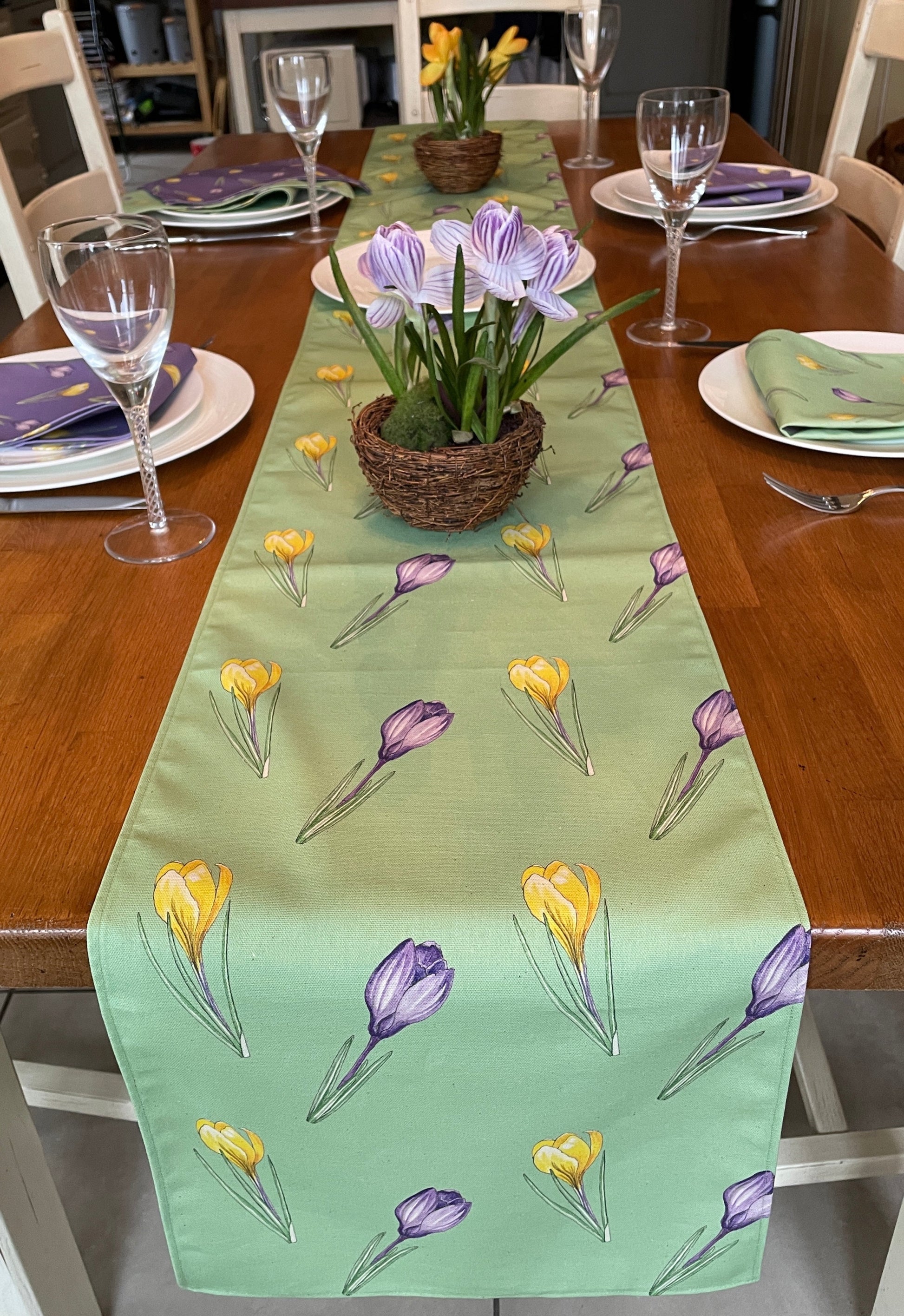 green fabric table runner with crocus illustration in yellow and purple