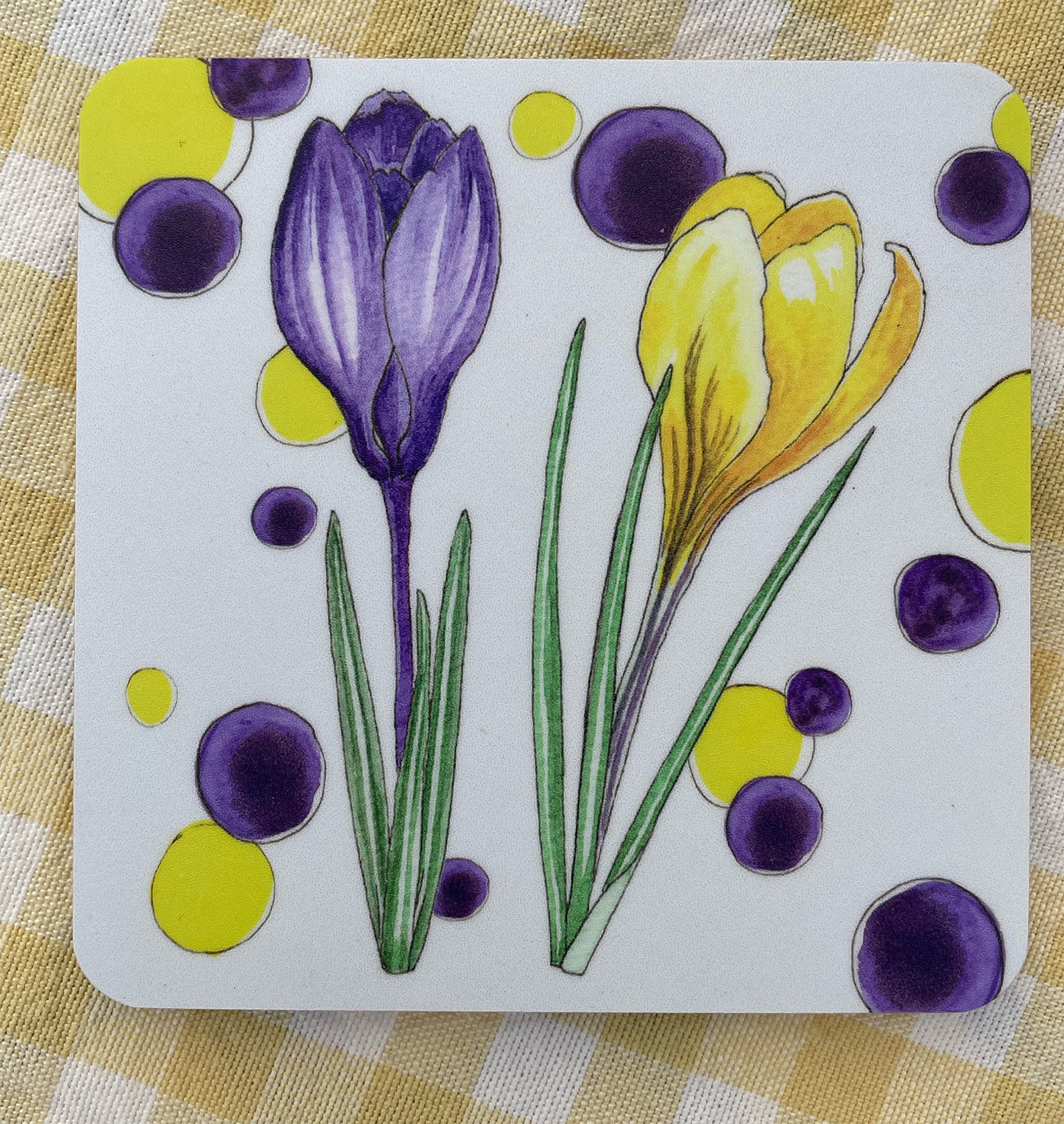 White cork based coaster with purple and yellow Crocus design