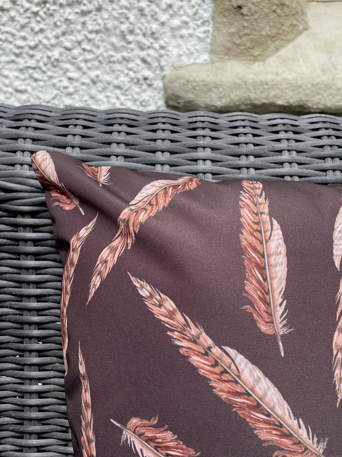 Close up of pheasant feather design on an outdoor water repellent cushion. In Brown